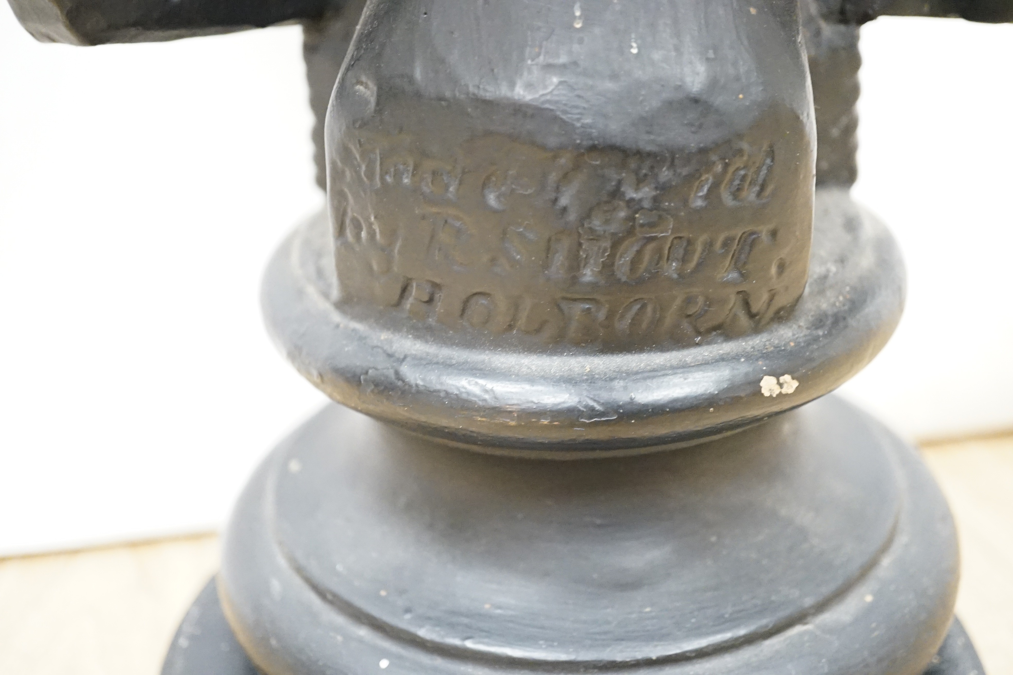 A black painted plaster bust of a judge, inscribed 1826, 49cms high.